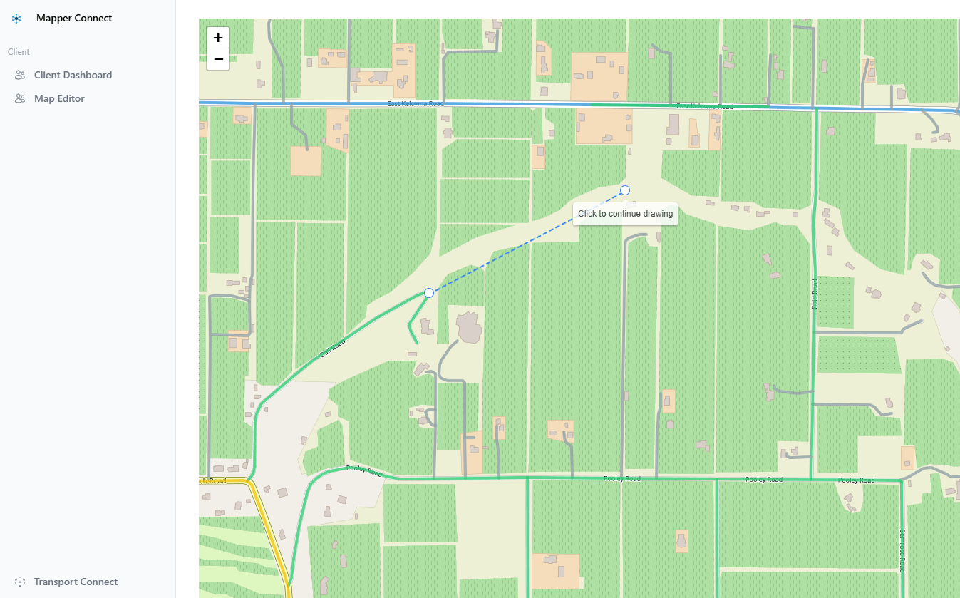 The Mapper road editor with a new road being drawn across a rural block, on the street basemap.